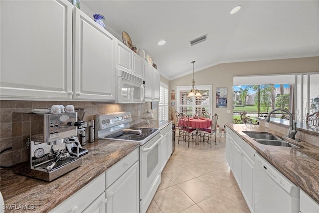 kitchen featuring white appliances, white cabinetry, lofted ceiling, and sink