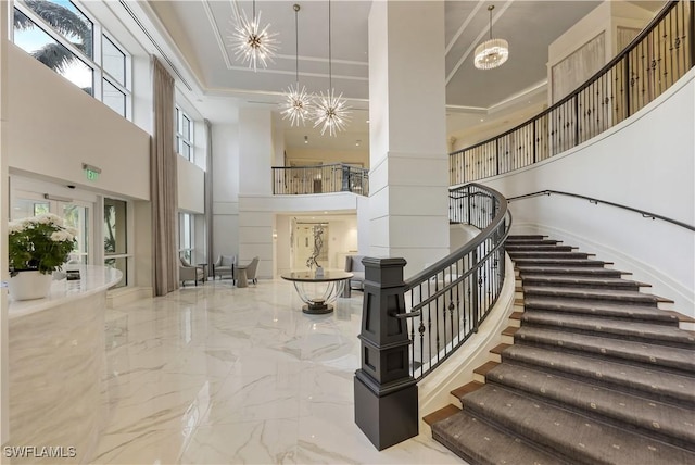 staircase featuring a high ceiling and a chandelier