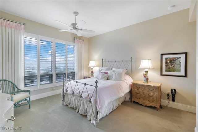 bedroom featuring ceiling fan and light carpet