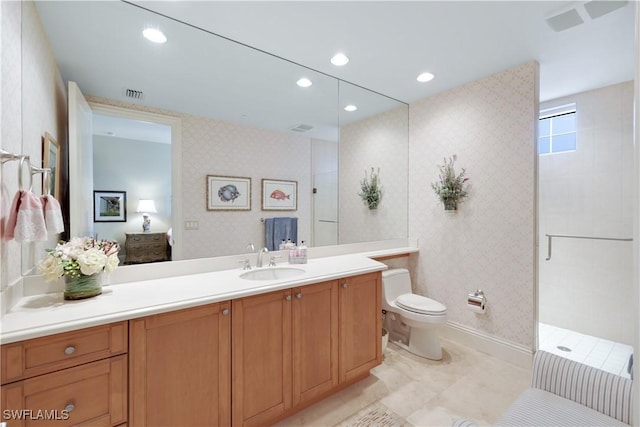 bathroom with vanity, tile patterned floors, toilet, and walk in shower