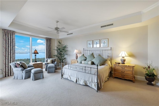 carpeted bedroom featuring crown molding, ceiling fan, and a tray ceiling