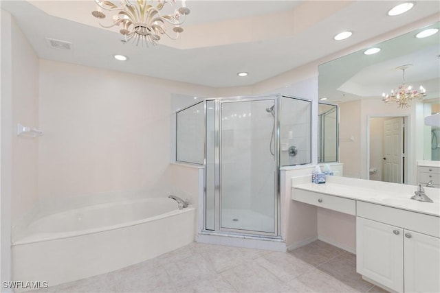 bathroom featuring a stall shower, visible vents, a raised ceiling, a notable chandelier, and a bath