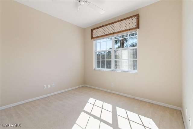 empty room with carpet, ceiling fan, and baseboards