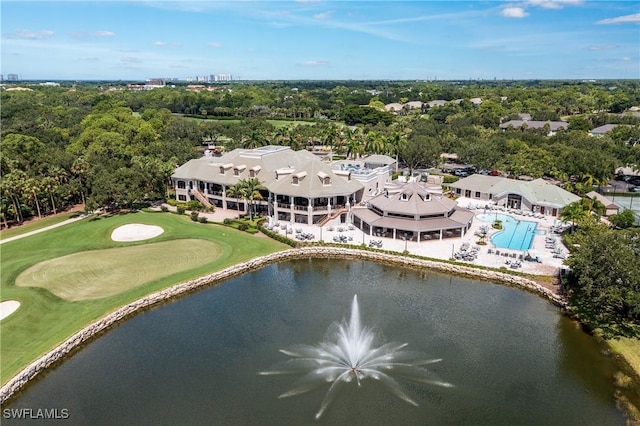 drone / aerial view with golf course view and a water view