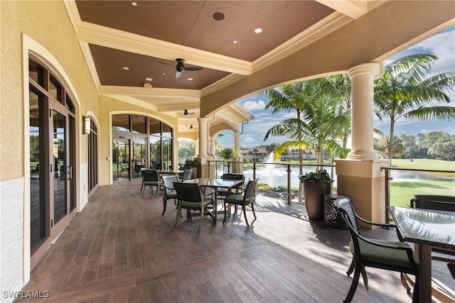 view of patio featuring a water view and ceiling fan