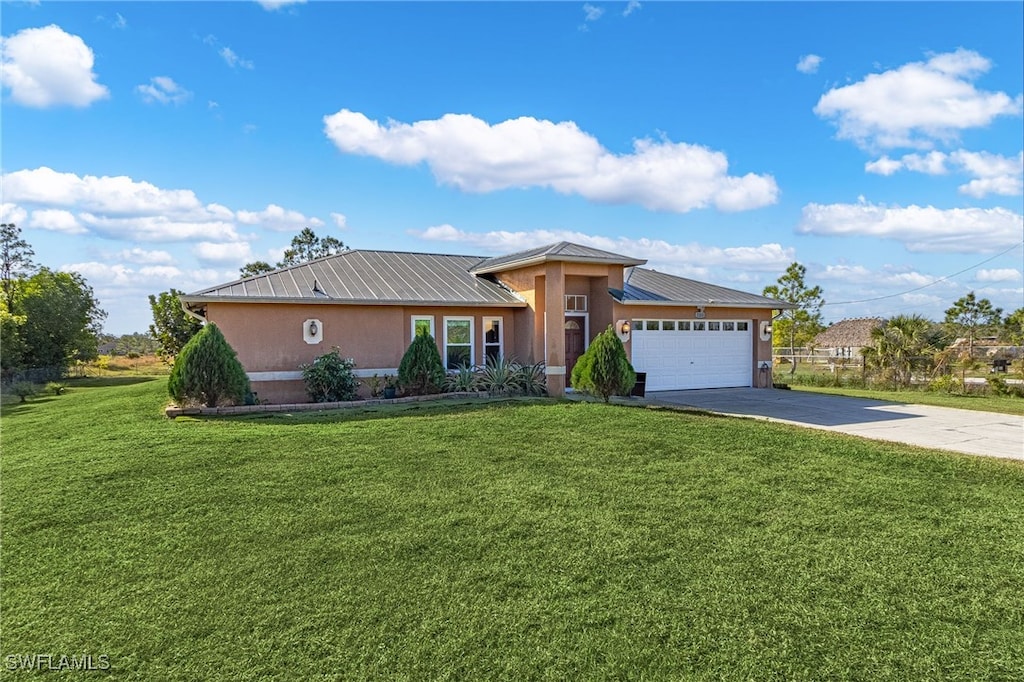 view of front of house with a front yard and a garage