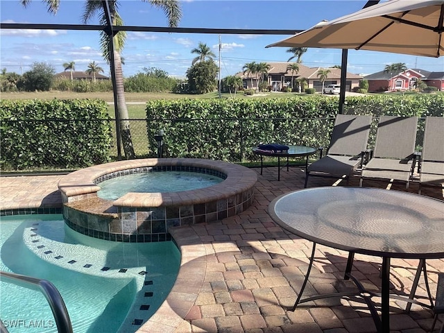 view of patio / terrace with an in ground hot tub