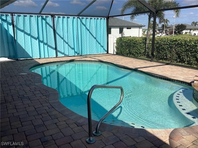 view of pool with a lanai