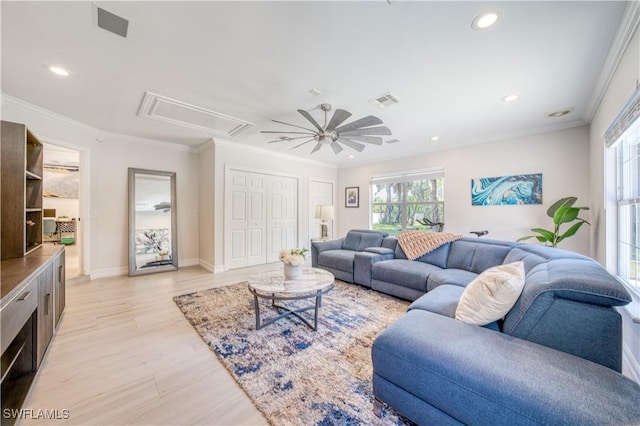 living room featuring light wood-type flooring, ceiling fan, and ornamental molding