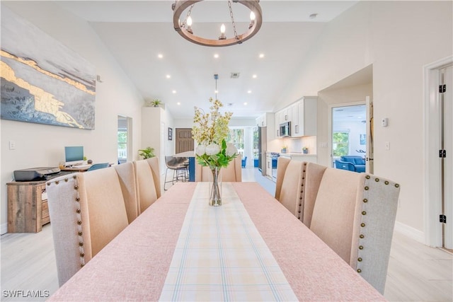 dining room with a chandelier, high vaulted ceiling, visible vents, and recessed lighting