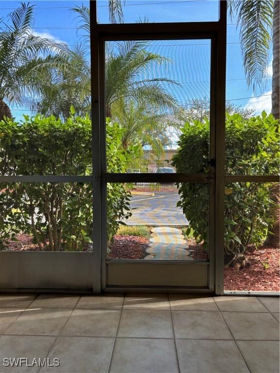 doorway to outside with tile patterned floors