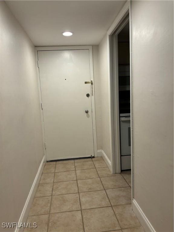 doorway to outside featuring light tile patterned flooring