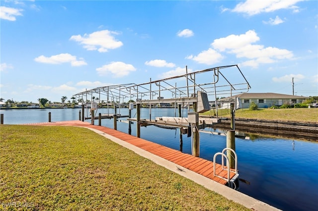 view of dock with a water view and a yard