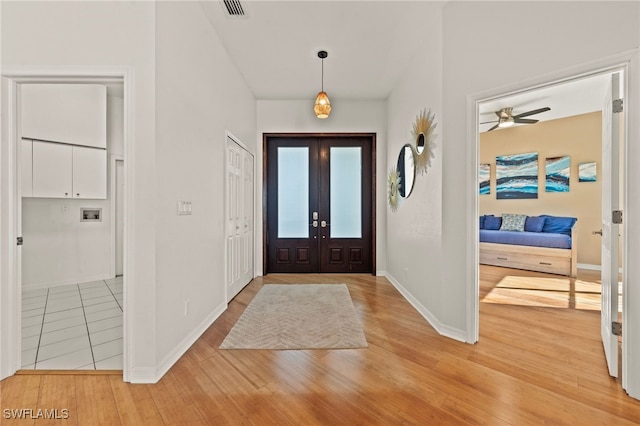 foyer entrance with french doors and wood-type flooring