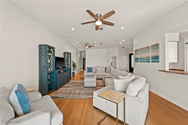 living room with ceiling fan and light hardwood / wood-style floors