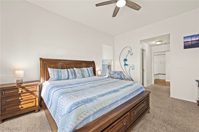 bedroom with ceiling fan, light colored carpet, and a closet