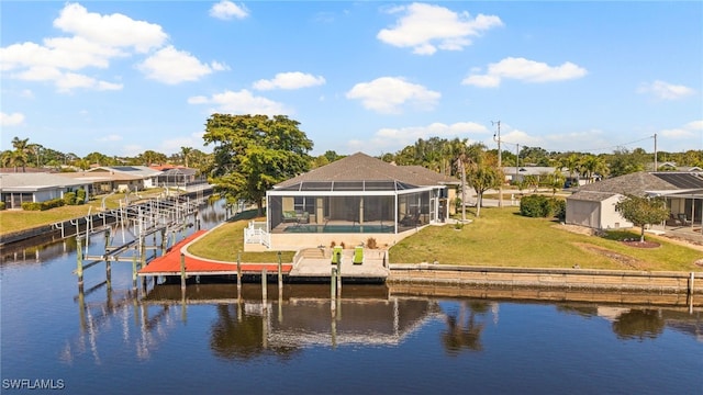 rear view of house with a pool, a water view, a yard, and glass enclosure