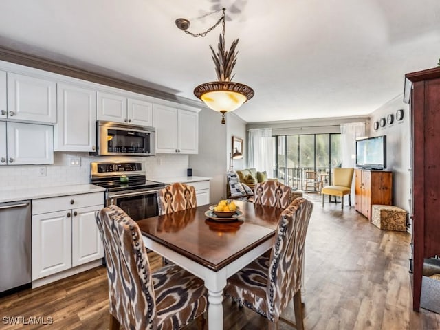 dining space featuring dark wood-type flooring