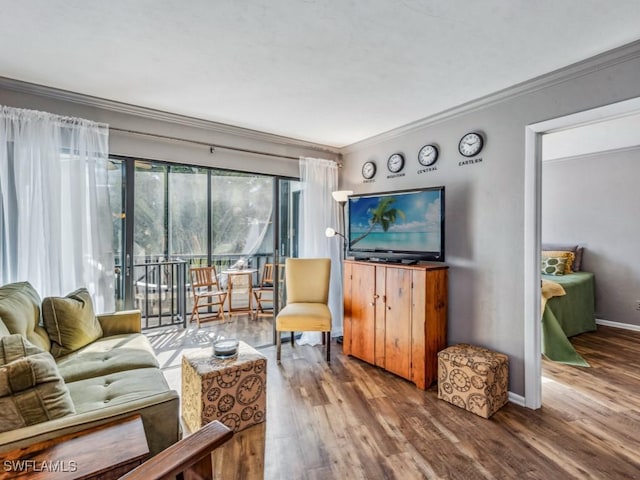 living room with hardwood / wood-style flooring and crown molding