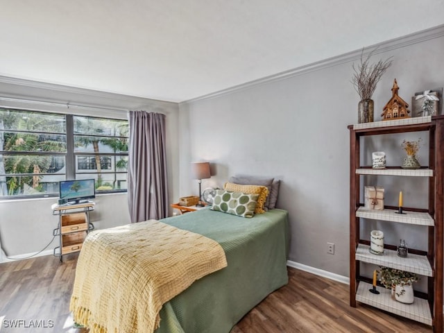 bedroom with crown molding and hardwood / wood-style floors