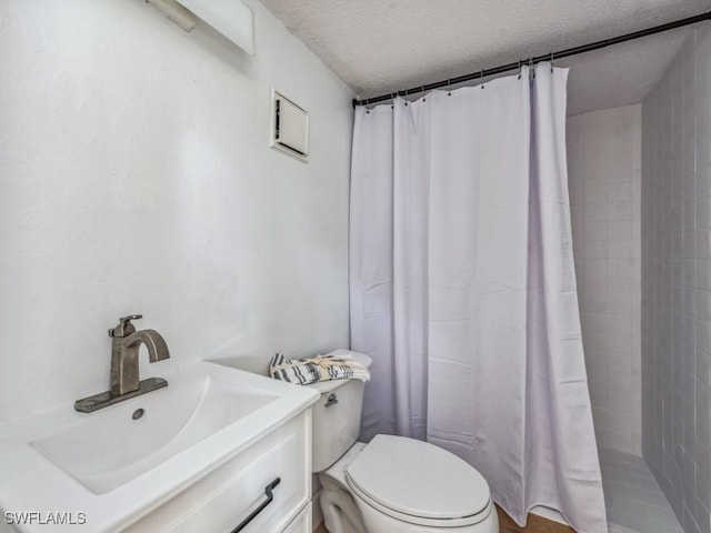 bathroom with a shower with shower curtain, toilet, sink, and a textured ceiling