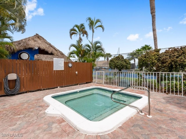 view of pool with a community hot tub and a patio