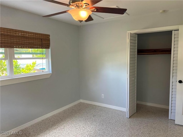 unfurnished bedroom with ceiling fan and a closet