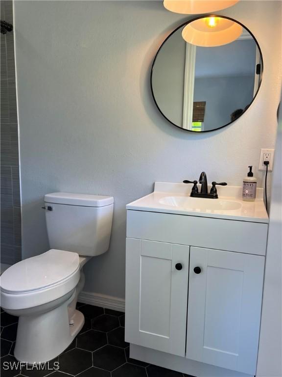 bathroom featuring tile patterned floors, toilet, and vanity