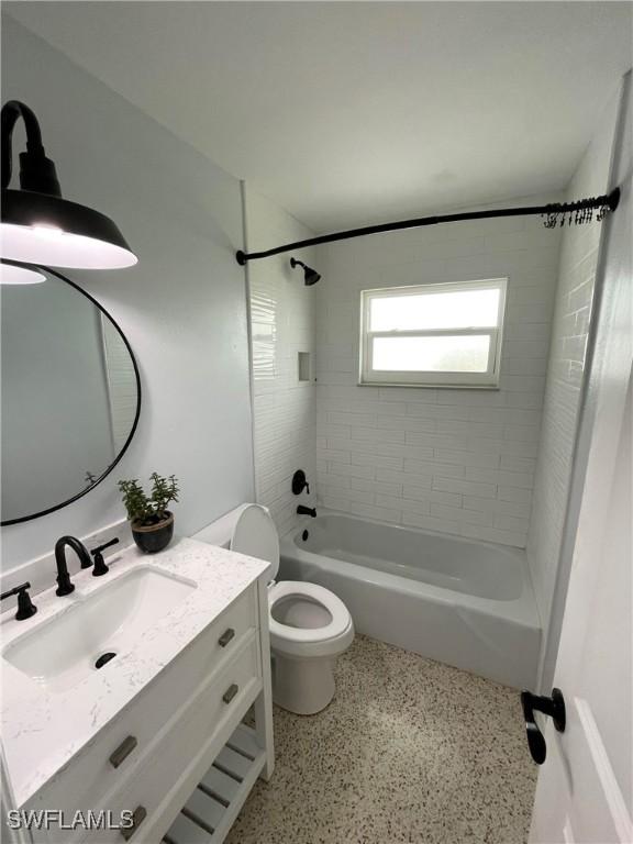 full bathroom with vanity, toilet, and tiled shower / bath combo