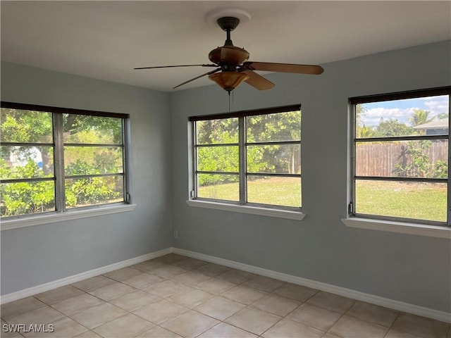 empty room featuring ceiling fan and light tile patterned flooring