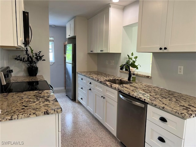 kitchen featuring white cabinetry, sink, stainless steel appliances, and light stone countertops