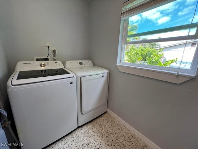 clothes washing area featuring independent washer and dryer