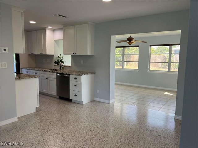 kitchen featuring sink, dishwasher, ceiling fan, white cabinetry, and dark stone countertops