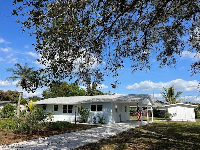 single story home featuring a carport and a front yard