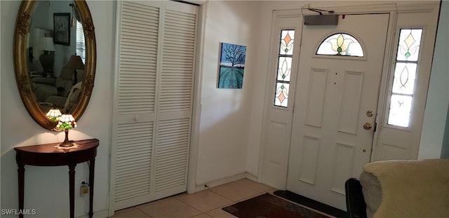 tiled foyer entrance with a wealth of natural light