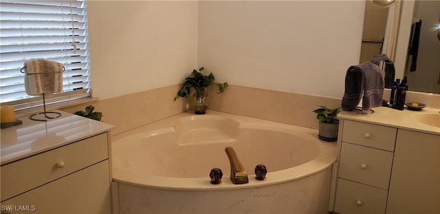 bathroom featuring a washtub and vanity