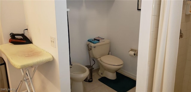 bathroom featuring tile patterned floors, walk in shower, a bidet, and toilet