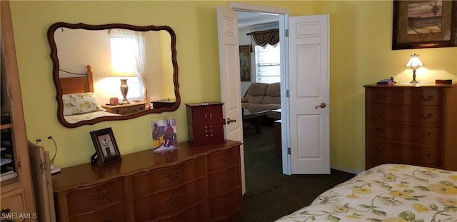 bedroom with dark colored carpet