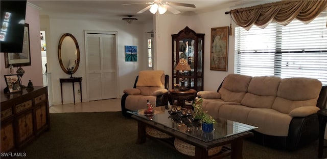 living room featuring dark tile patterned floors and ceiling fan