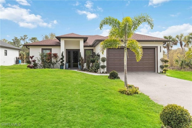 view of front of house with a front yard and a garage