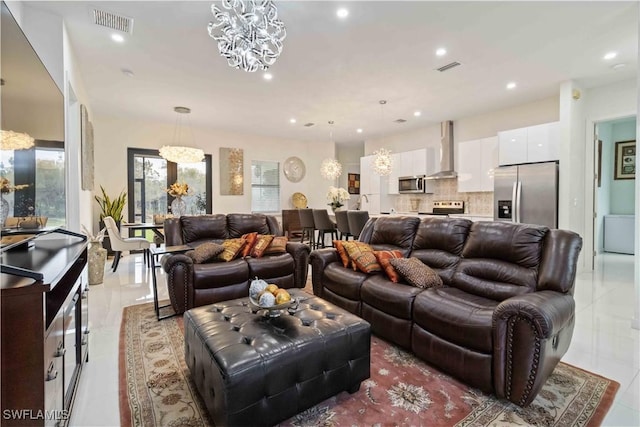 living room with an inviting chandelier and light tile patterned flooring