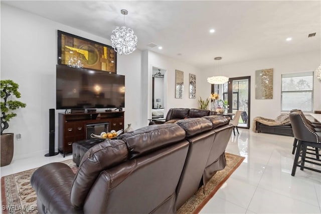 living room with light tile patterned floors and an inviting chandelier