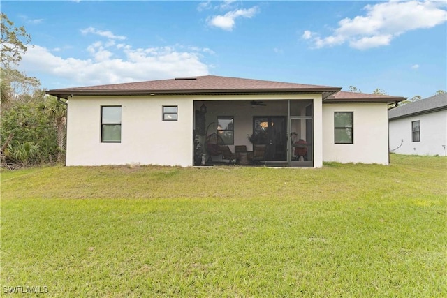 back of house with a sunroom and a yard