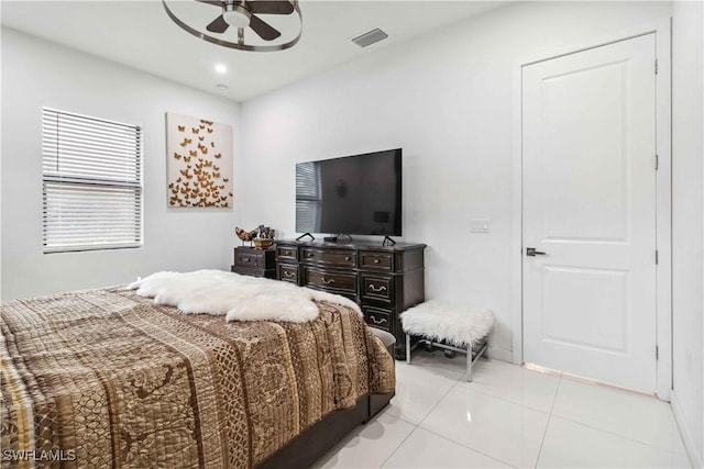 tiled bedroom with ceiling fan