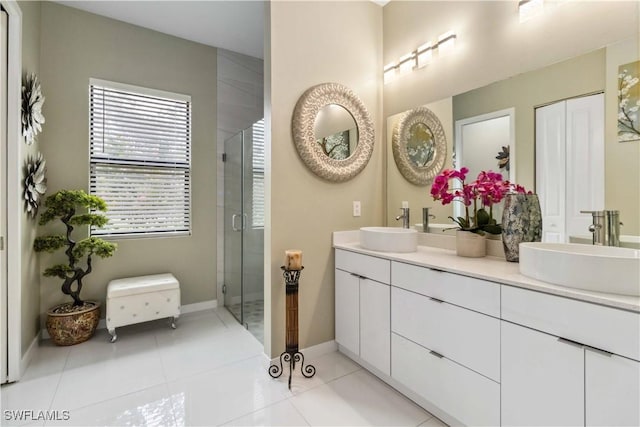 bathroom featuring vanity, tile patterned flooring, and a shower with door