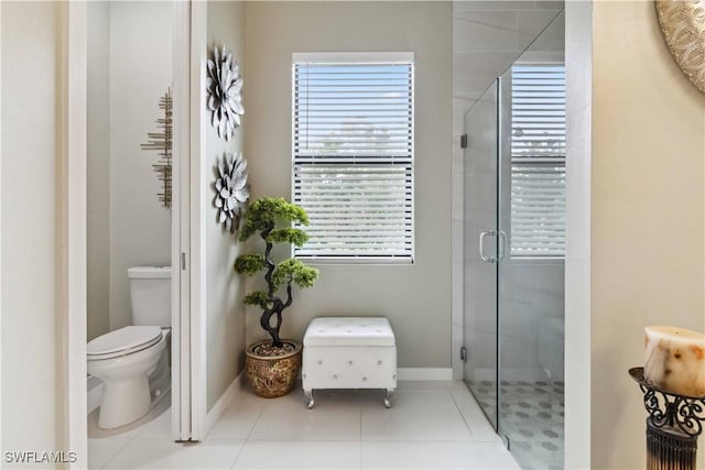 bathroom featuring toilet, an enclosed shower, and tile patterned floors