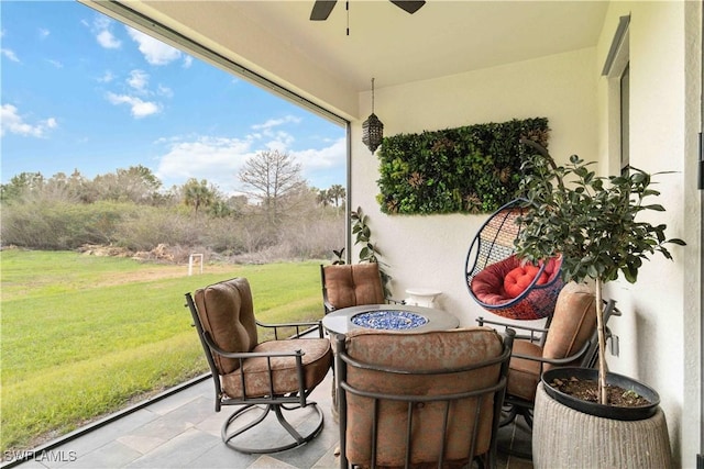 view of patio / terrace featuring ceiling fan and a fire pit