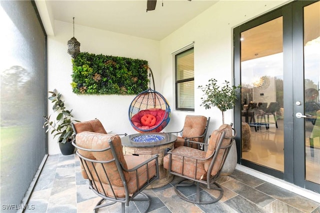 view of patio / terrace featuring french doors and a fire pit