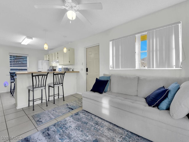 tiled living room featuring ceiling fan