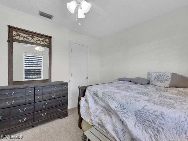 bedroom with light carpet and ceiling fan